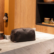 Styled Fit Perspective of Vince Full-Grain Leather Toiletry Bag نسائي on Model - Natural Daylight Drape